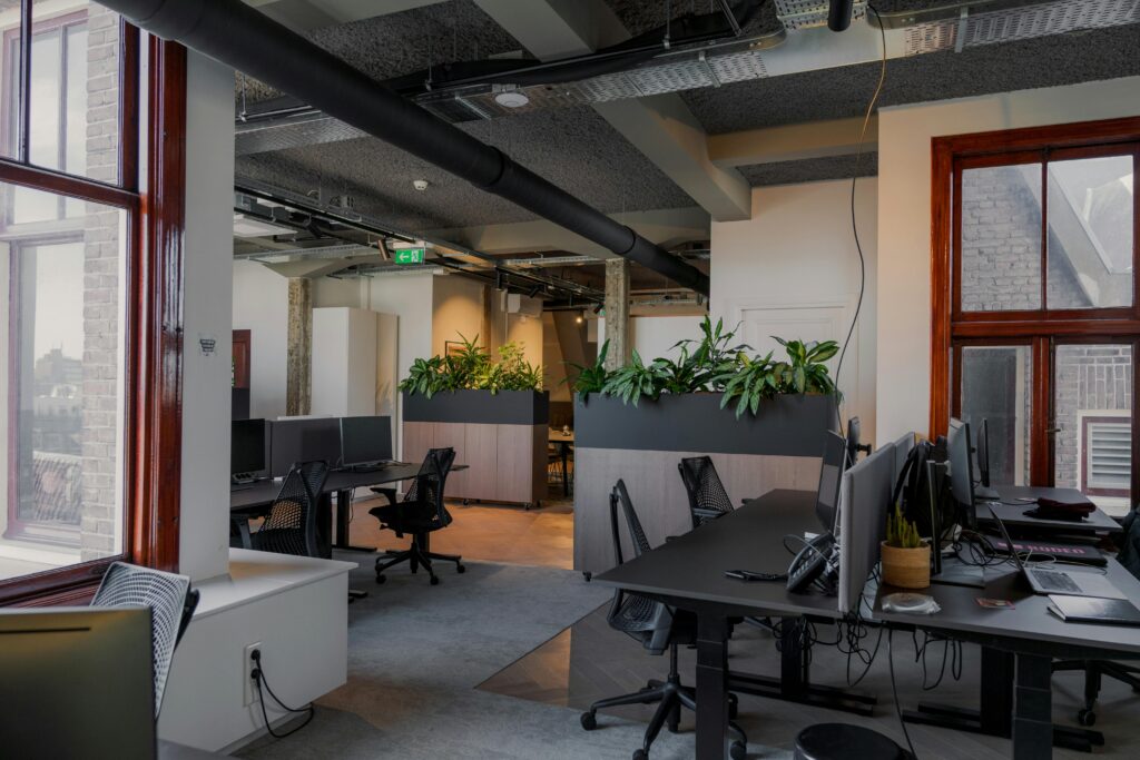 Contemporary office space with desks and plants in Amsterdam.